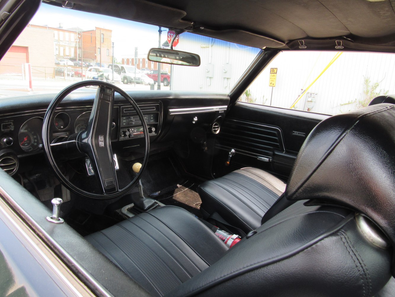 Classic 1969 muscle car interior with black dashboard and leather seats