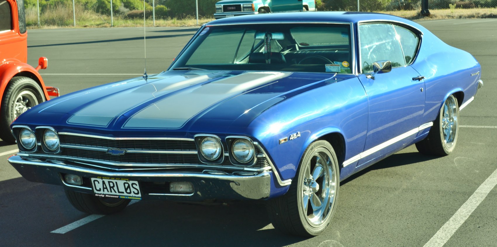 Dual round headlights and sleek sport coupe body with racing stripes