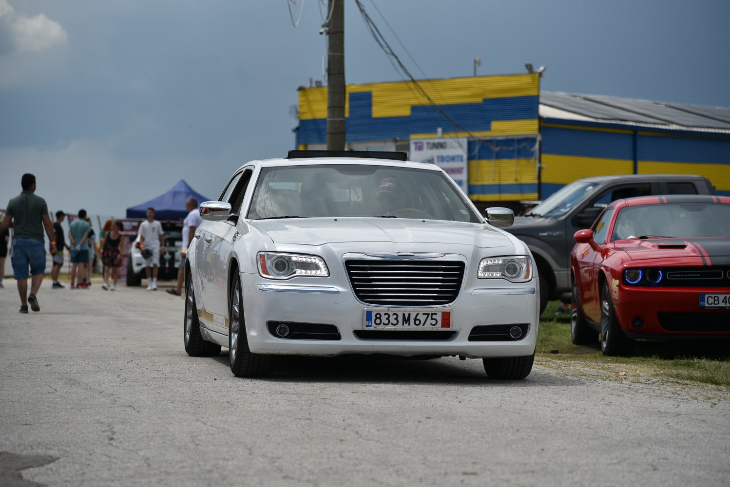 Front view of mid-size luxury sedan with LED headlights and chrome grille