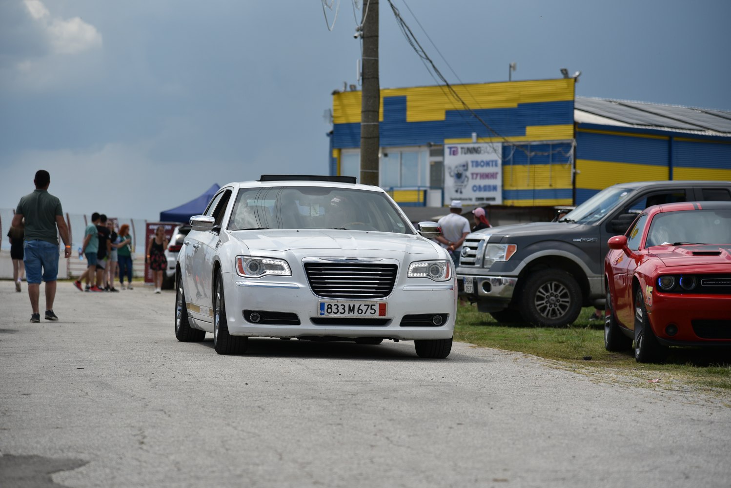 Front grille and LED headlights of a white luxury sedan