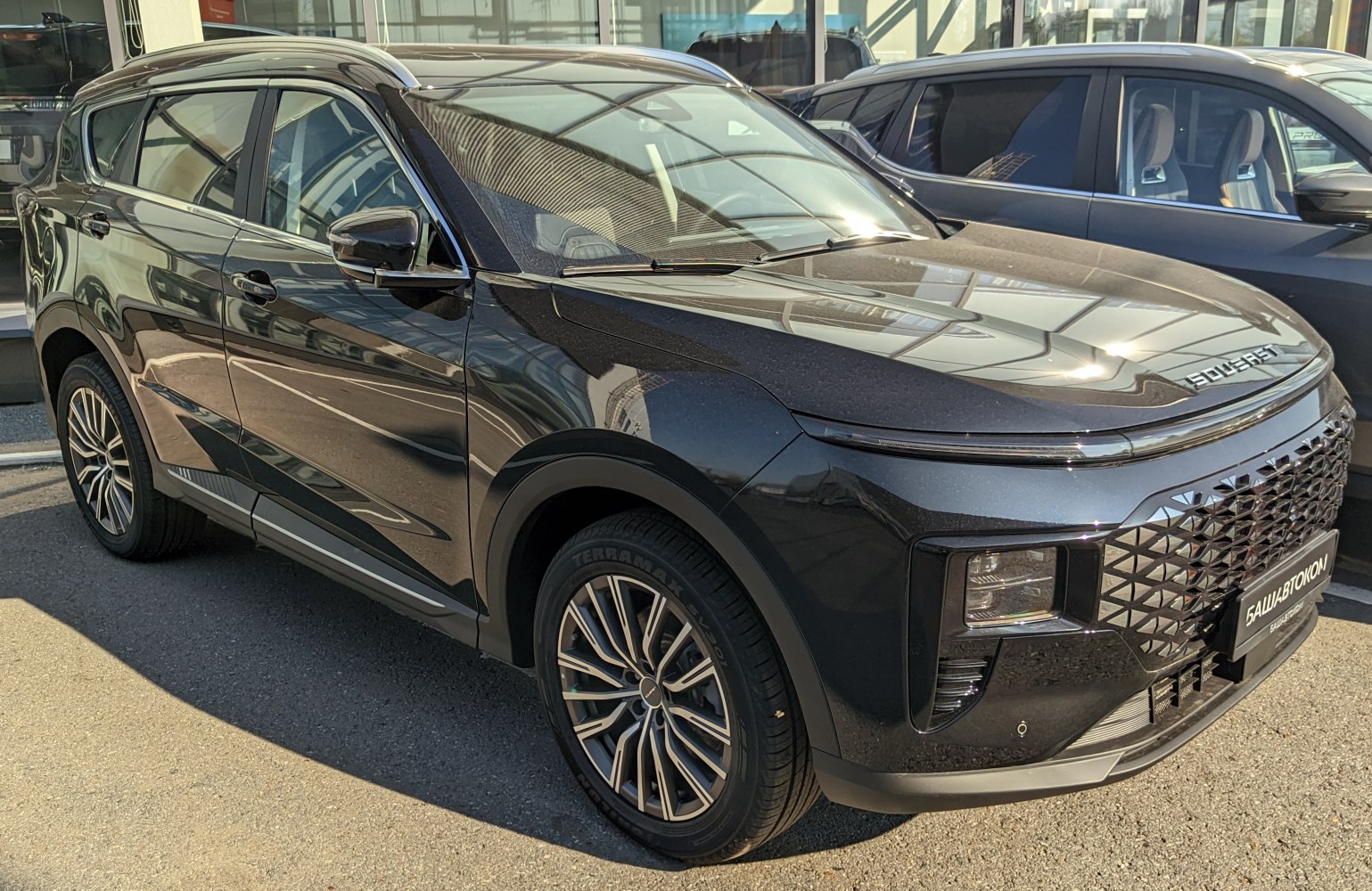 Modern front design and multi-spoke alloy wheels on a black SUV