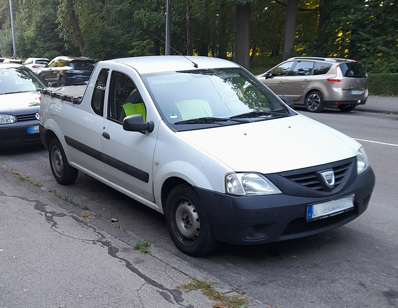 White compact pick-up with extended cargo bed and black front bumper