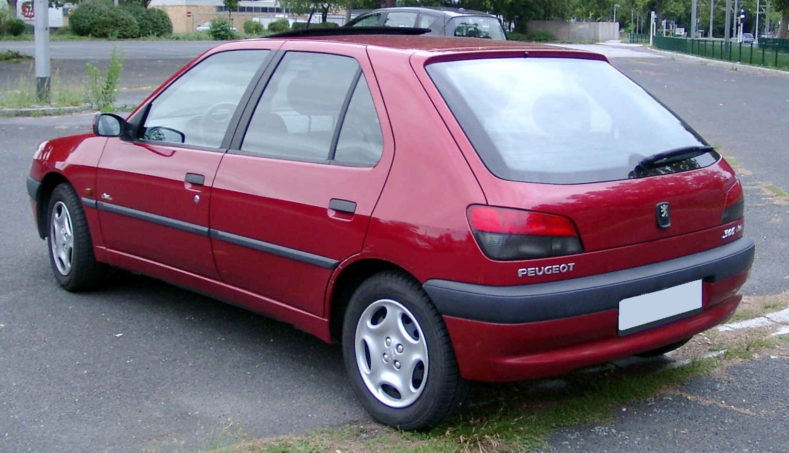 Rear and side view of a red five-door hatchback with distinct taillights