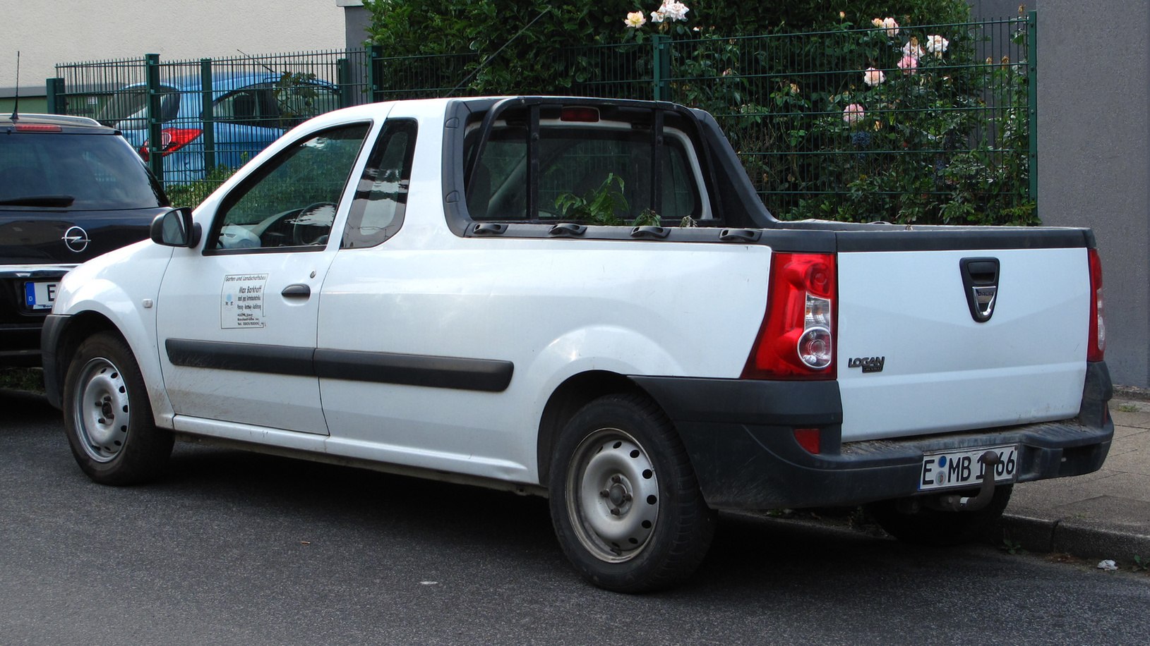 Pickup truck with extended cab and open cargo bed, white.
