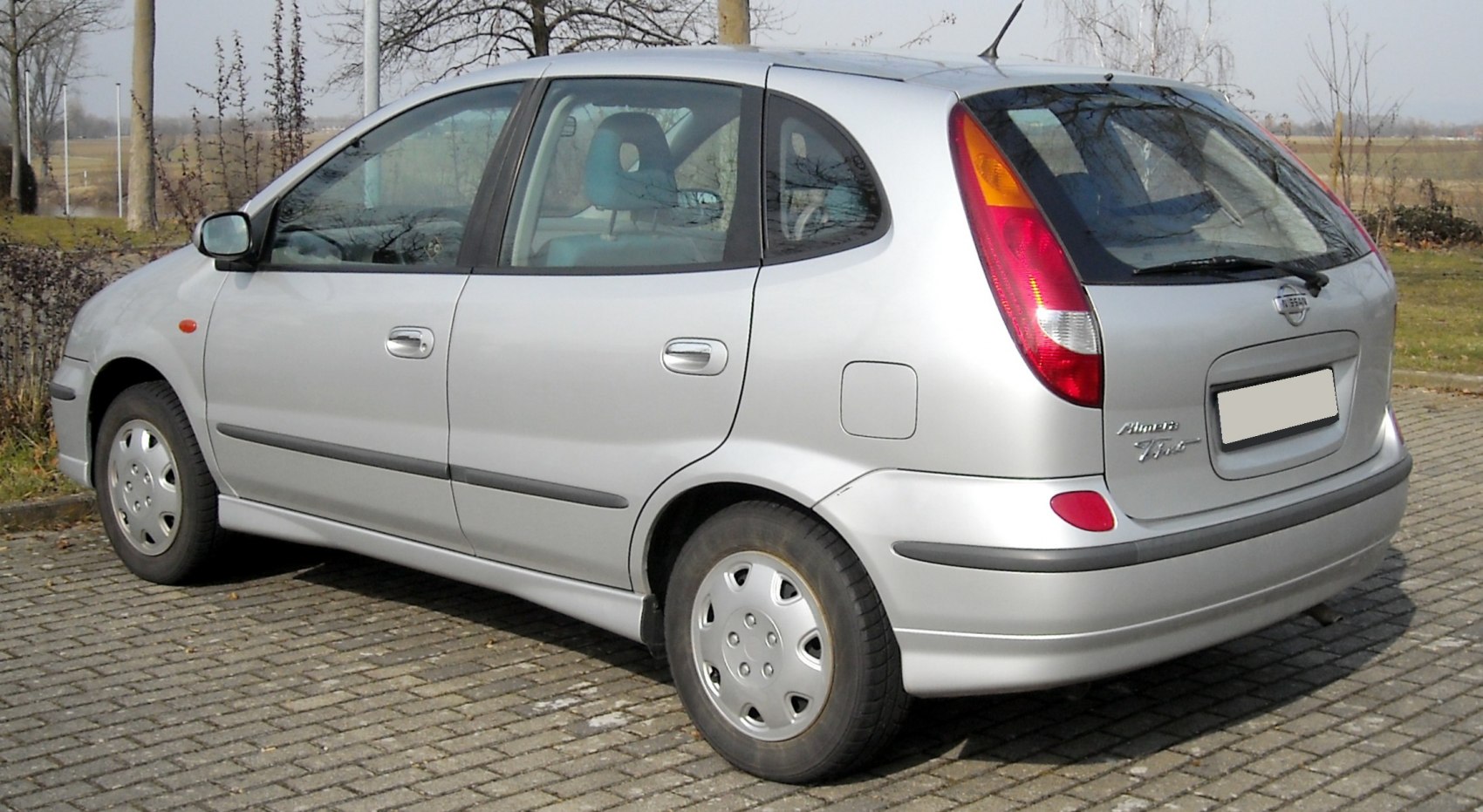 Rear side view of a compact hatchback with distinctive tall taillights and smooth body lines