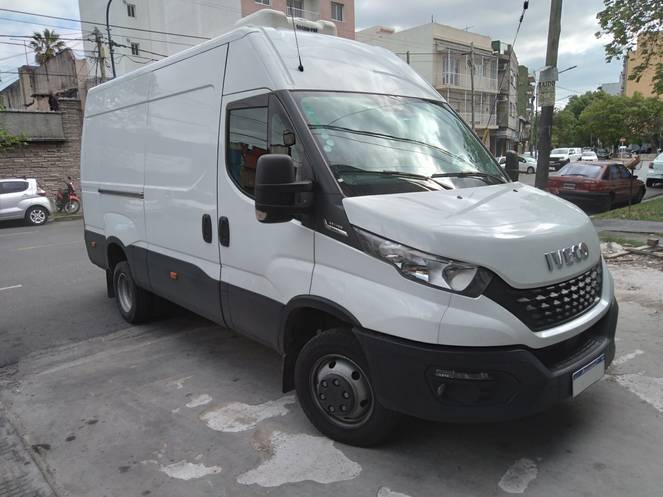 Front and side view of a high roof white panel van with modern headlights