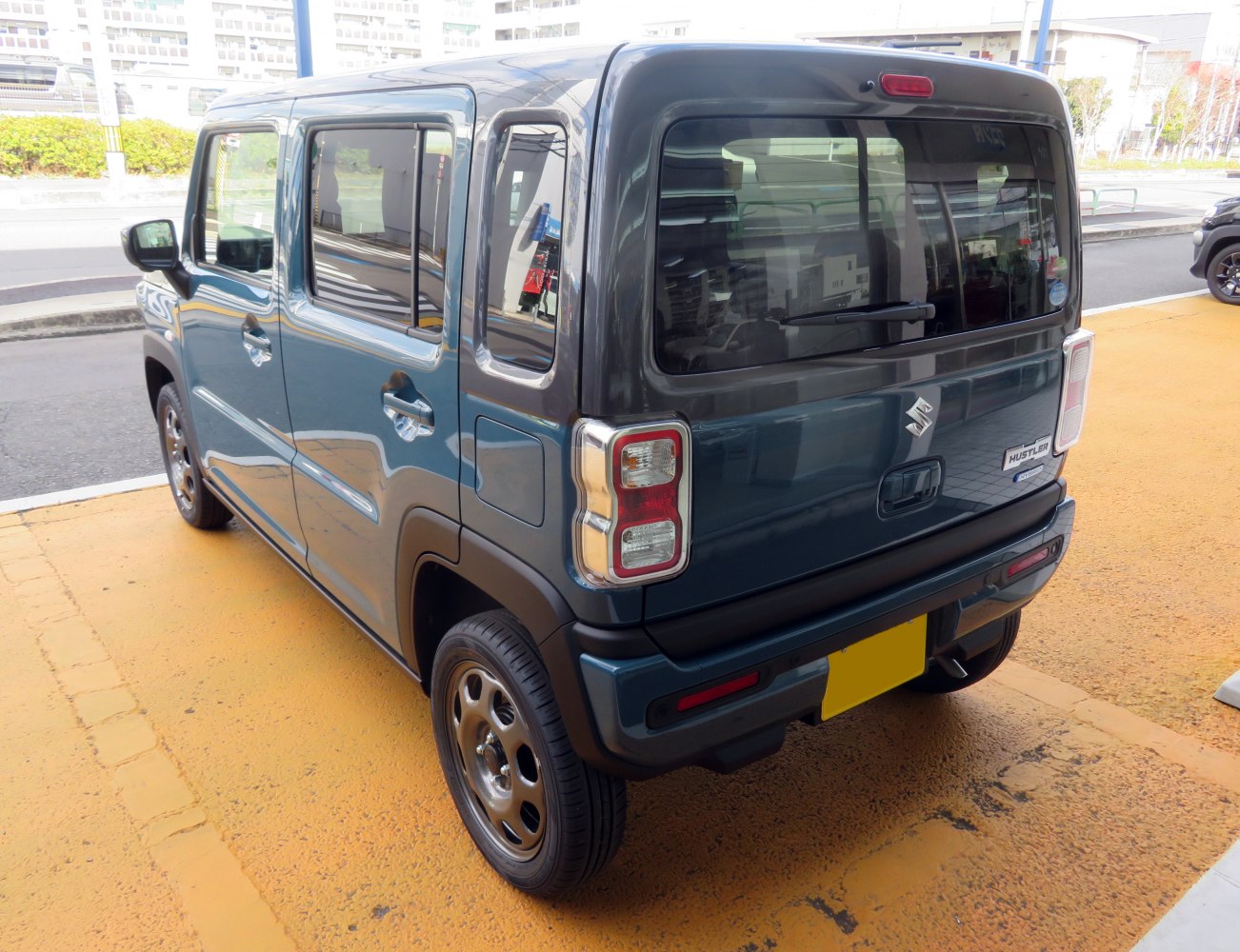 Rear view of boxy compact SUV with distinctive taillights and rear window wiper