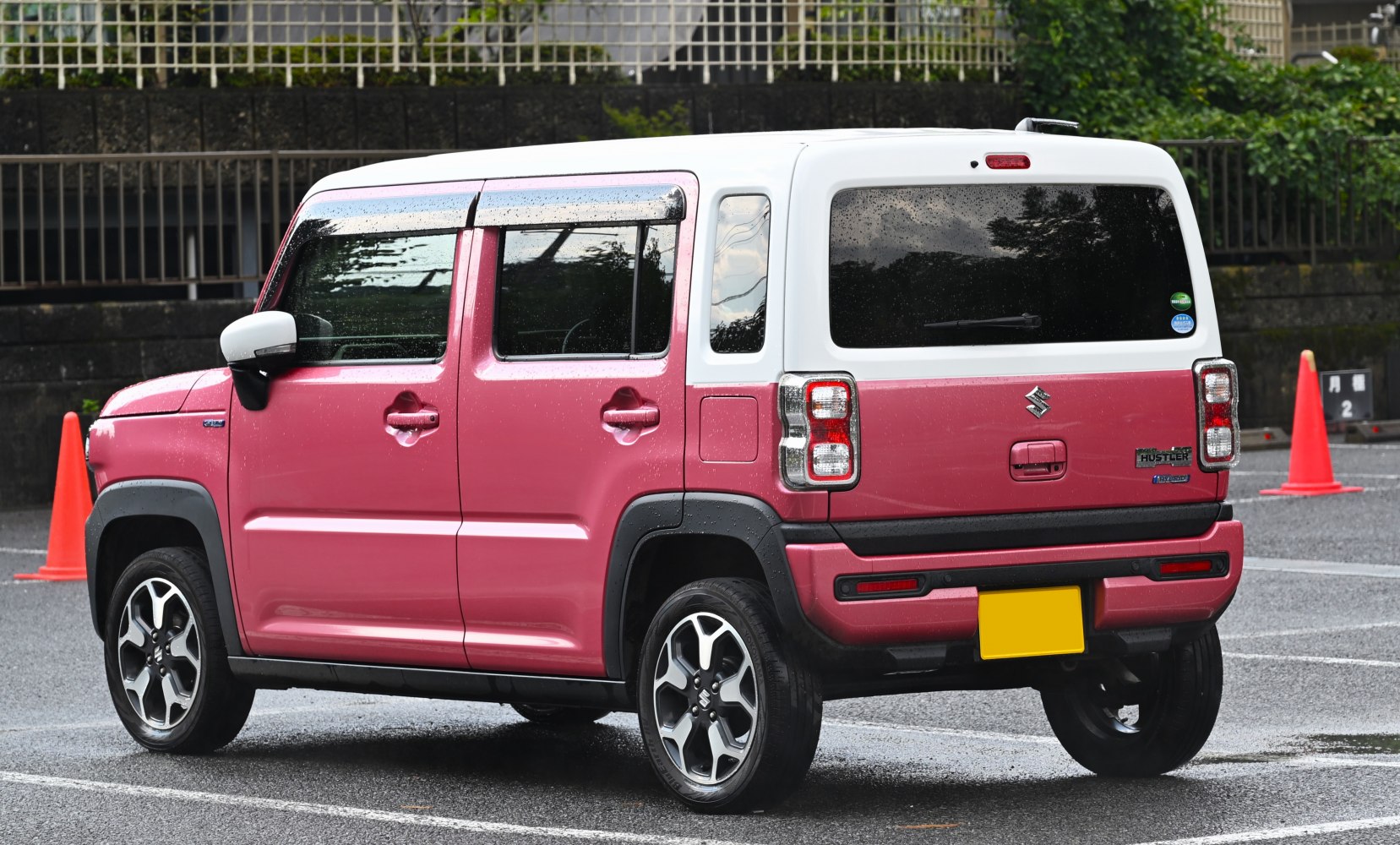 Rear side view of a compact SUV with boxy shape and dual-tone paint
