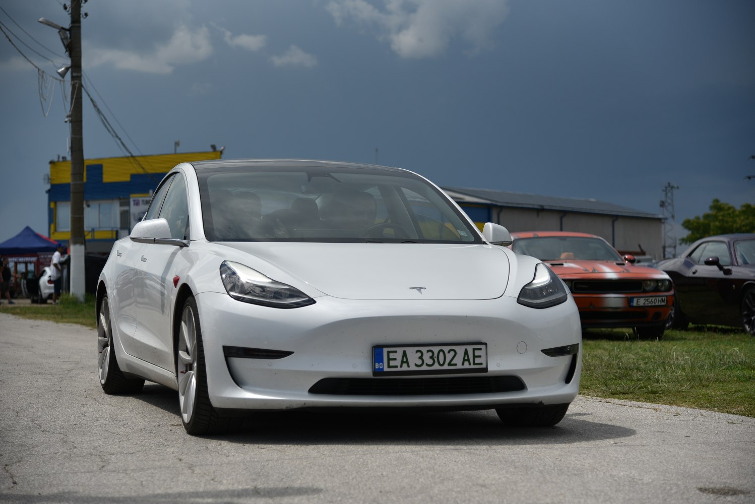 Front view of white electric sedan with sleek headlights and smooth design