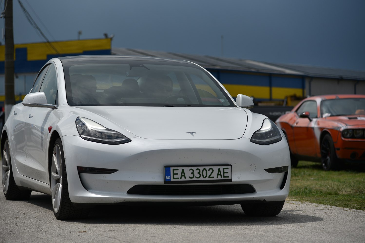 Front view of white electric sedan with LED headlights and aerodynamic shape