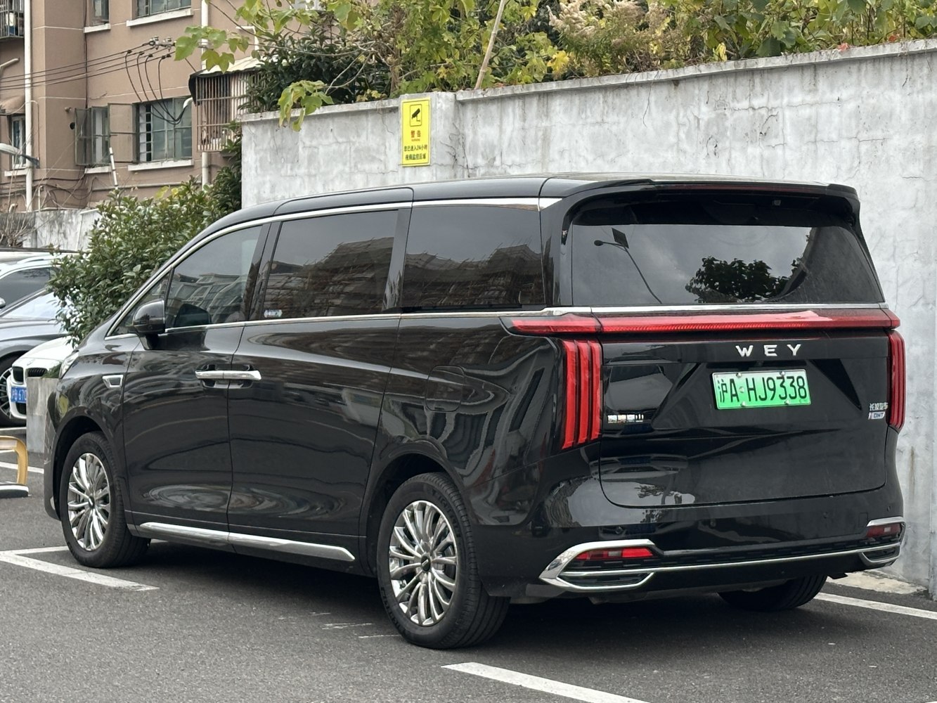 Black luxury SUV rear side with vertical LED tail lights and tinted windows