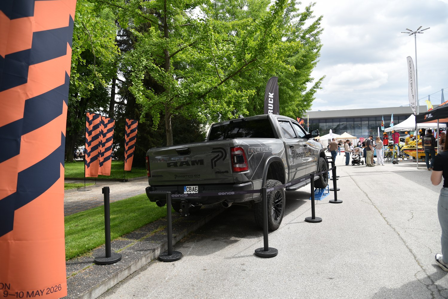 Lifted off-road pickup rear with black rims and rugged tires