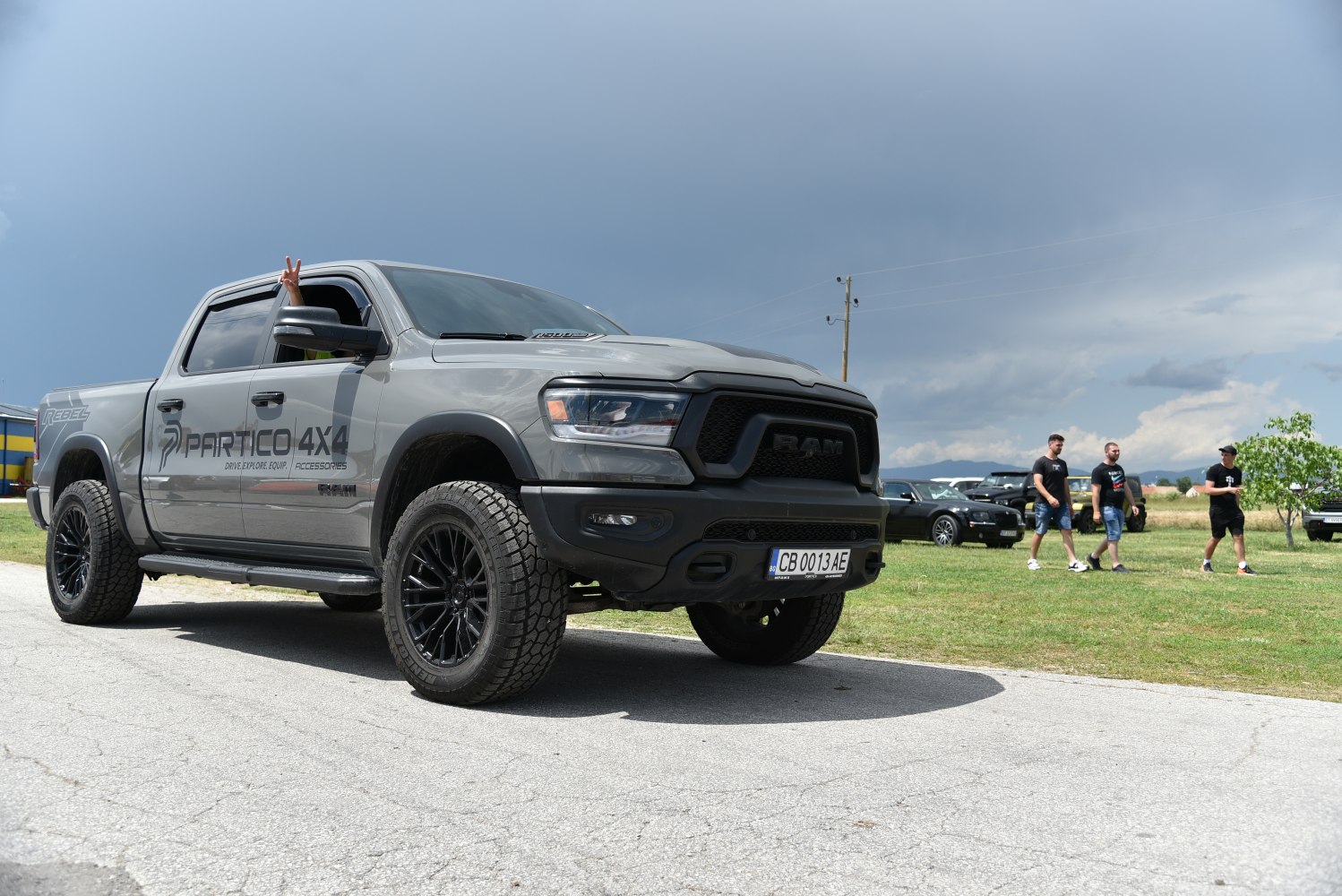 Front-side view of off-road pickup with rugged tires and sporty grille