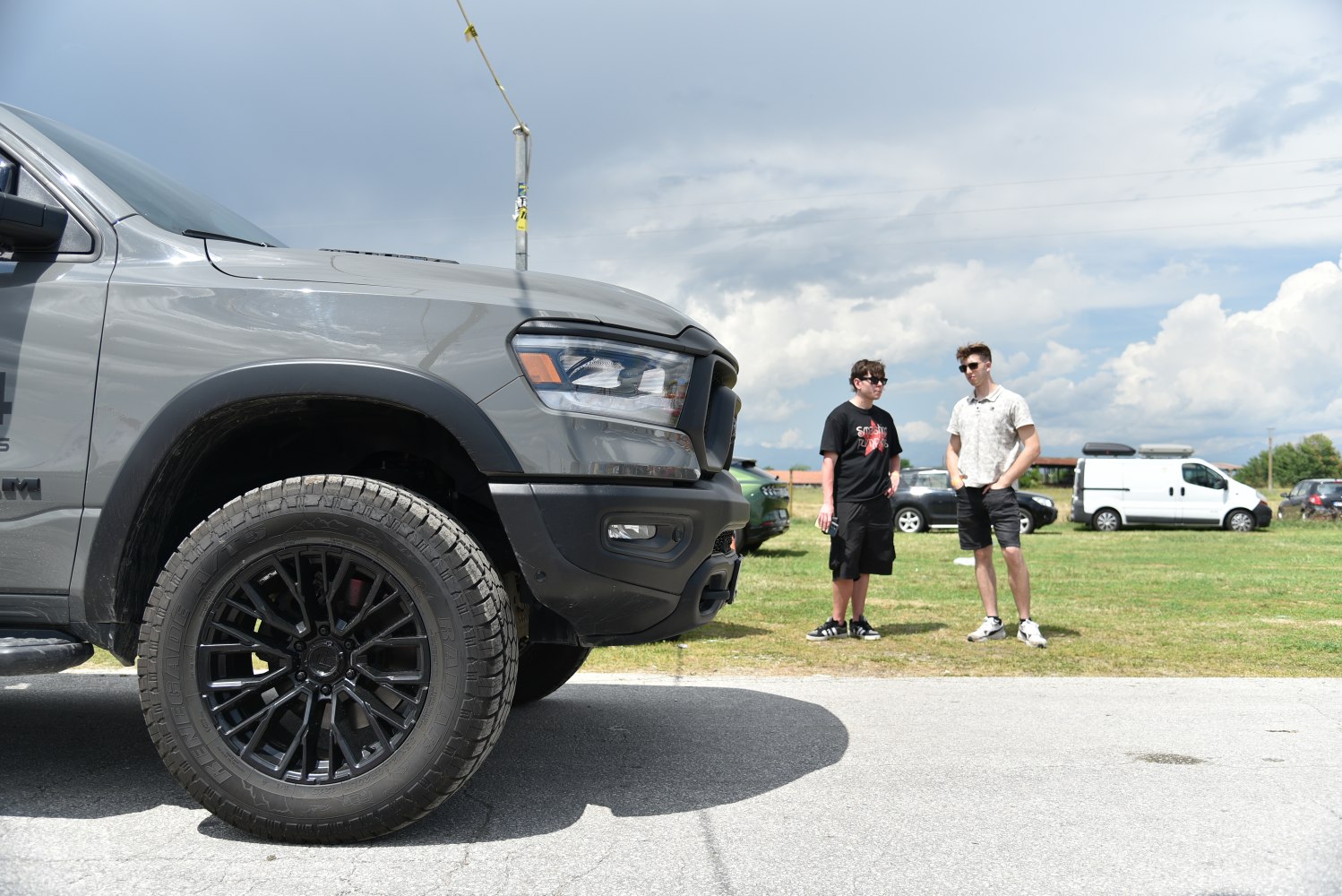 Close-up of truck front side with black alloy wheel and headlight