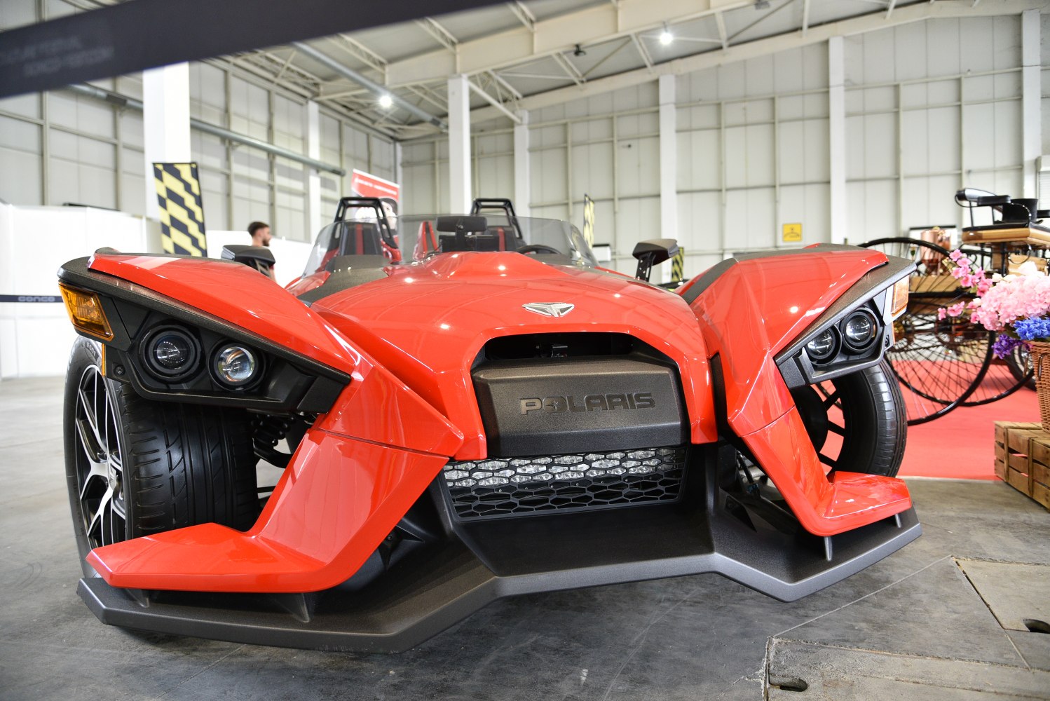 Angular headlights and aerodynamic front of a three-wheeled sport vehicle.