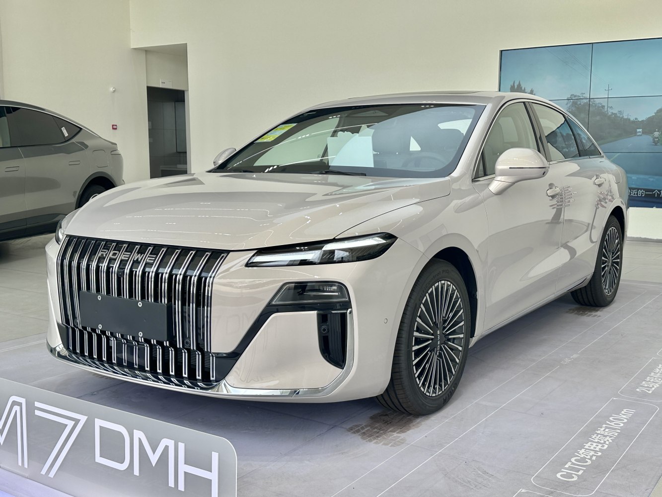 Bold vertical grille and sleek LED headlights on modern luxury sedan.
