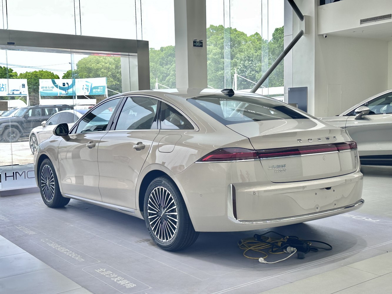 Rear and side profile of a modern sedan with intricate wheel design