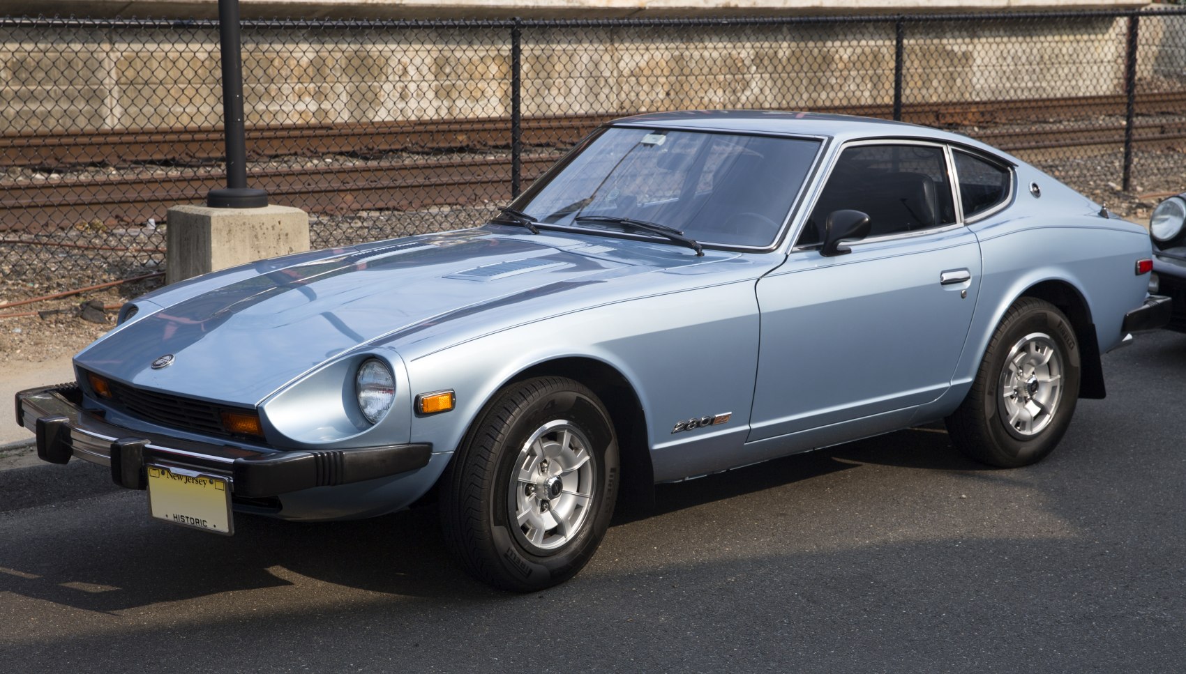 Vintage coupe with pop-up round headlights and sleek alloy wheels