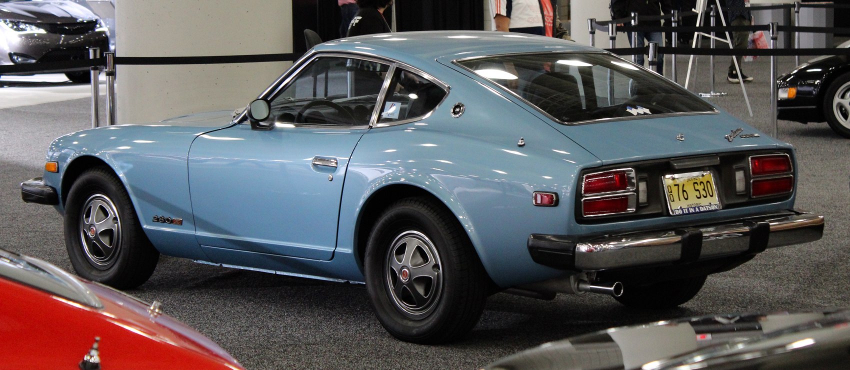 Vintage sports coupe with distinct rear design and side emblem.