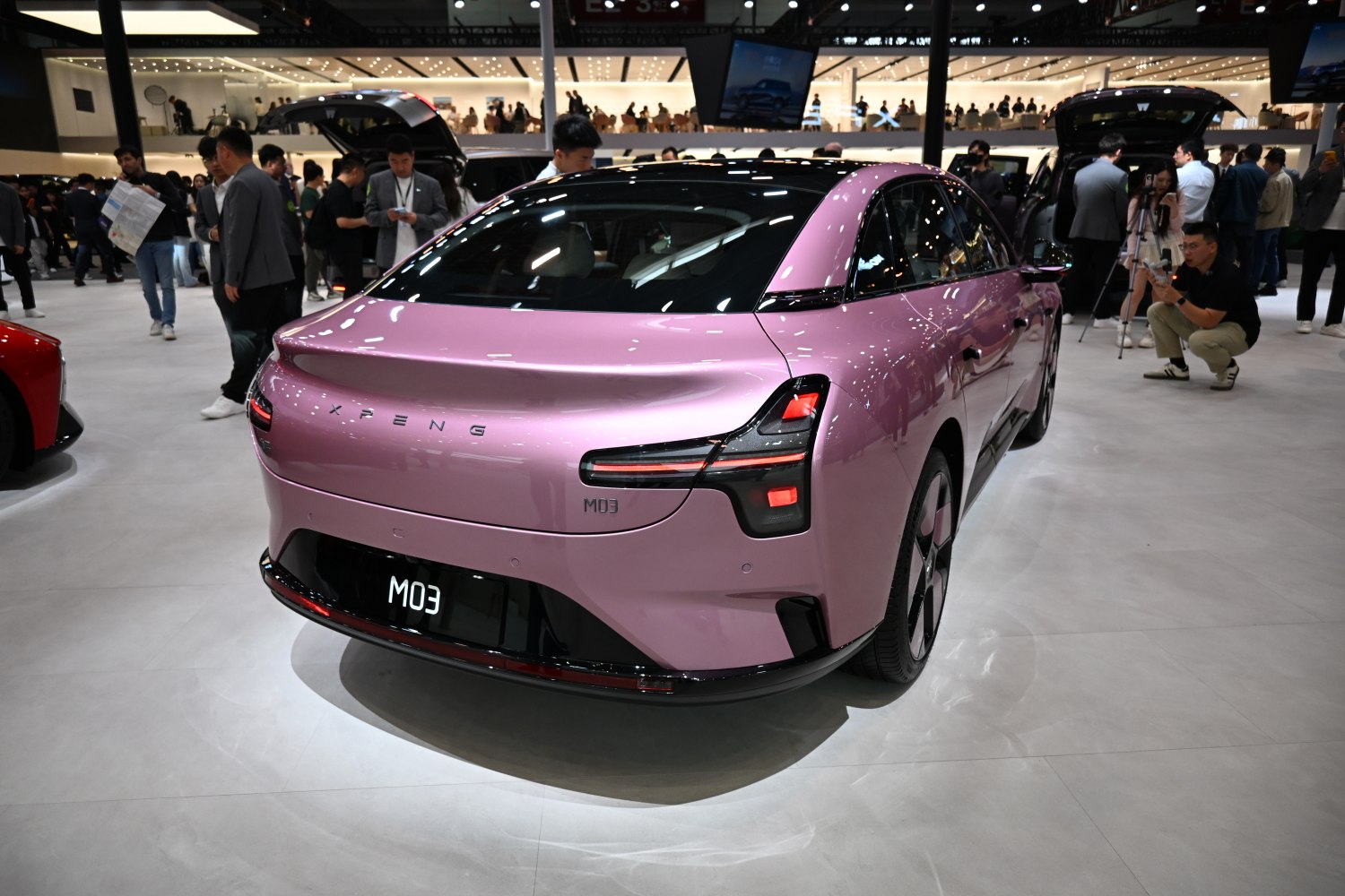 Rear view of a sleek electric sedan with distinct taillights and smooth body lines
