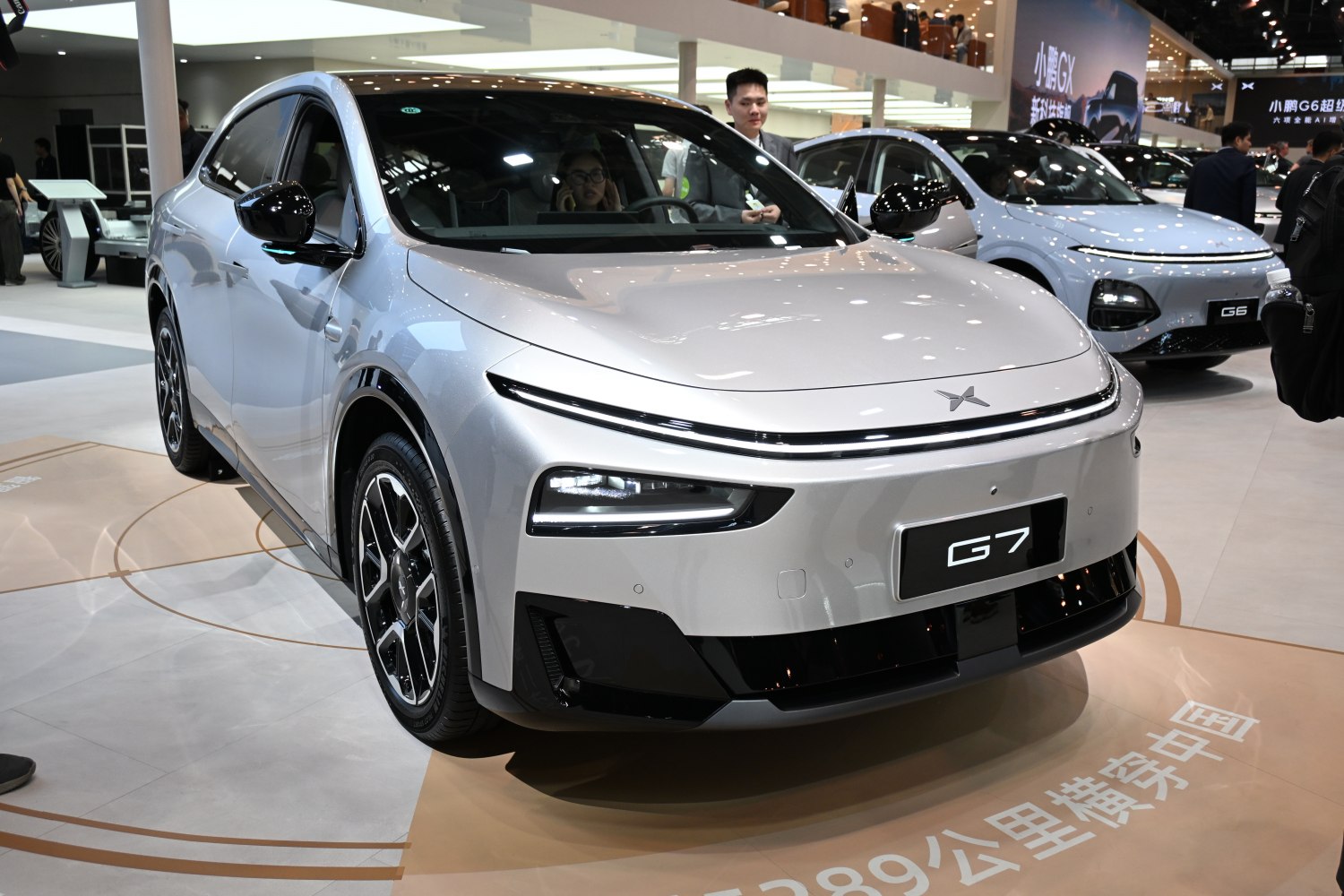 Sleek front view of an electric SUV with LED daytime running lights and aerodynamic features.