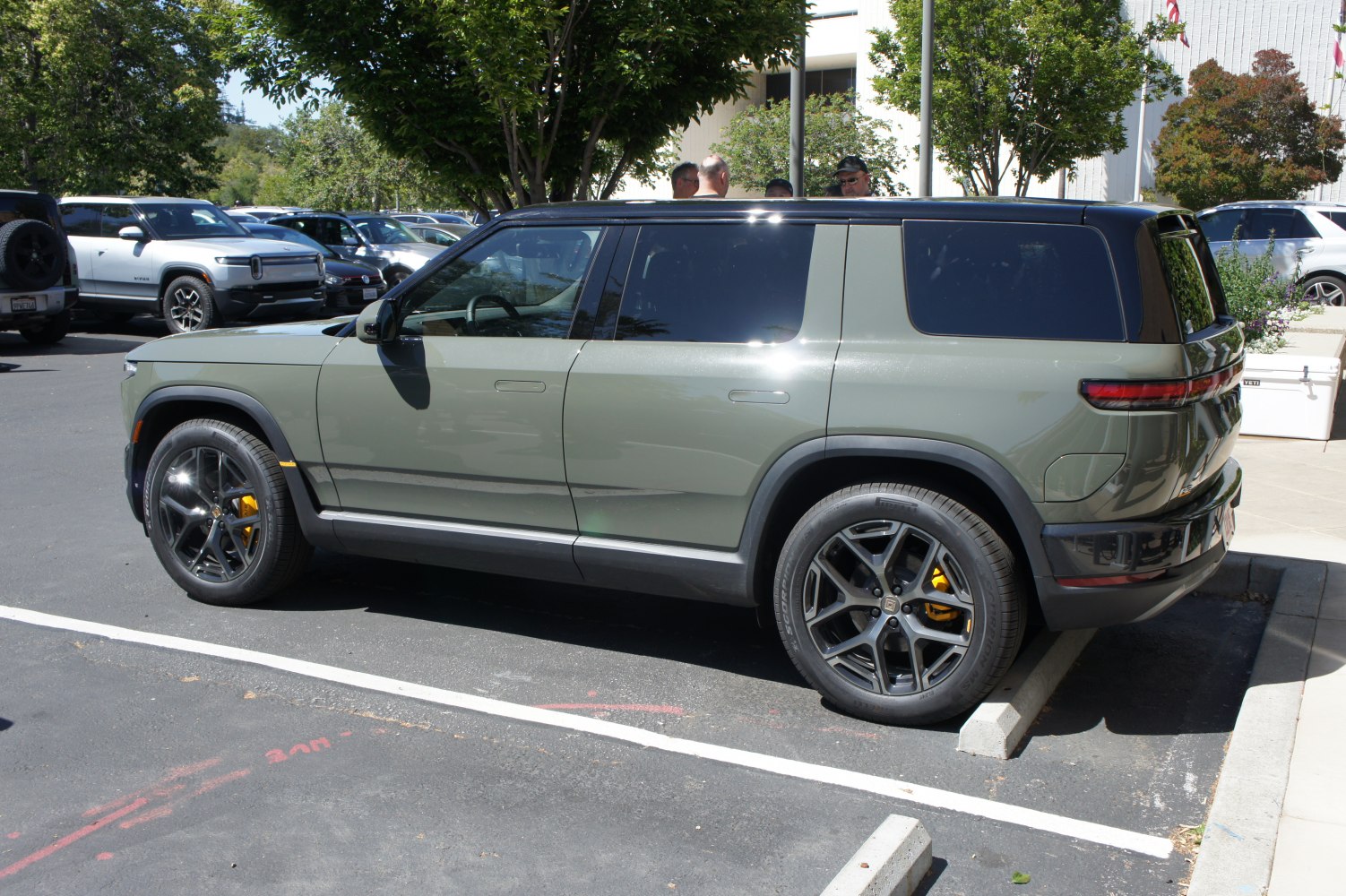 Side view of electric SUV with black roof and yellow brake calipers
