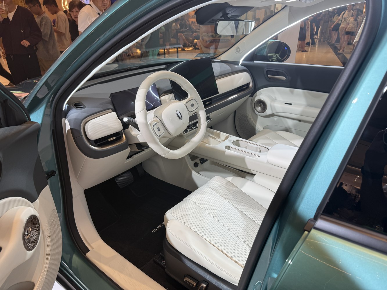 Modern car interior with digital dashboard and white leather seats