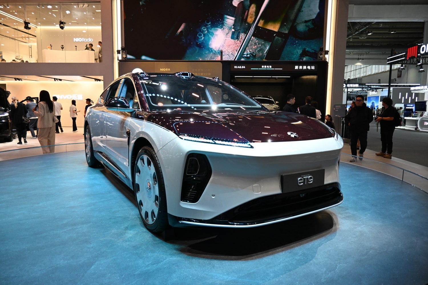 Sleek electric sedan front with futuristic headlights and aerodynamic styling