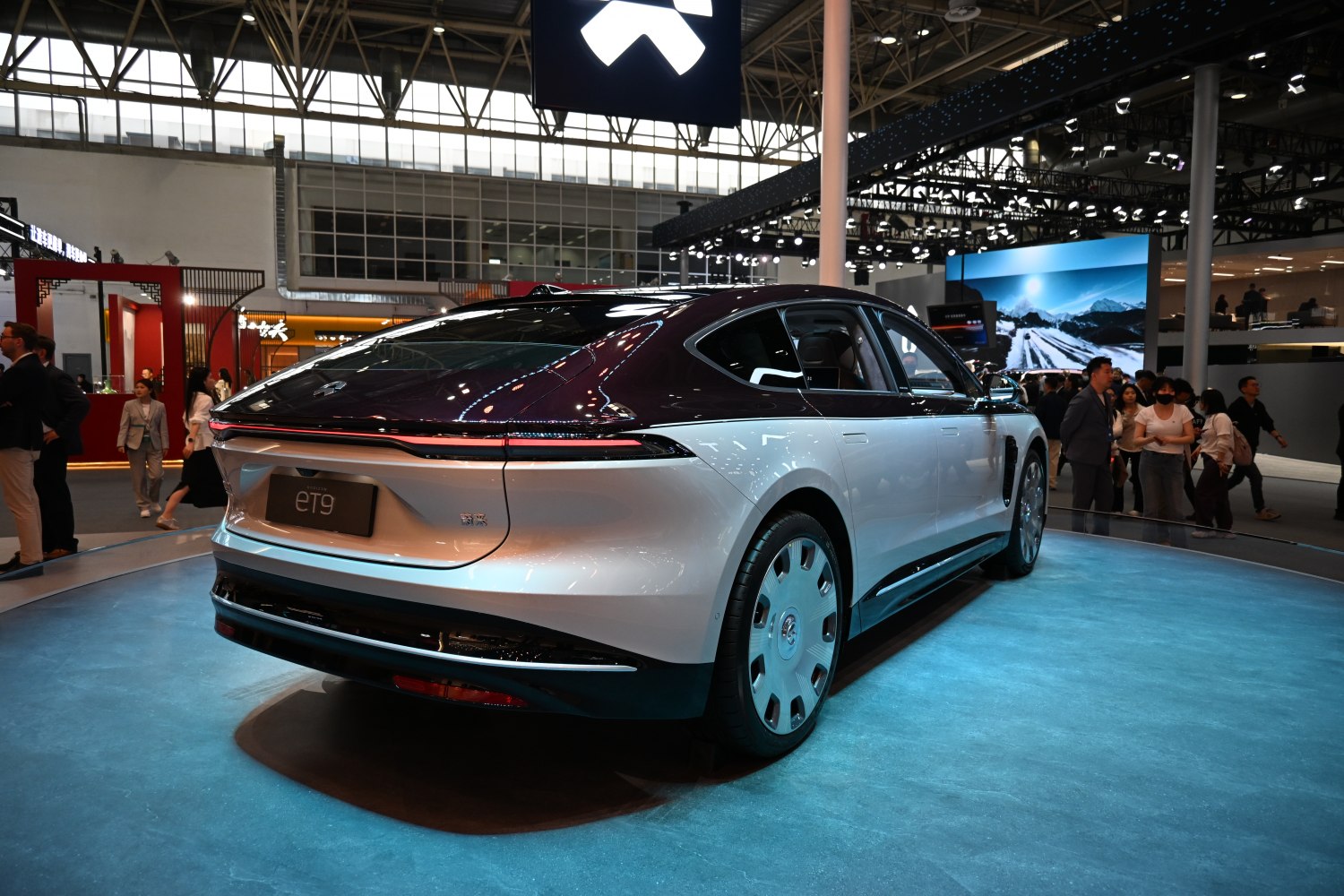 Sleek rear view of electric luxury sedan with distinctive taillights and aerodynamic wheels