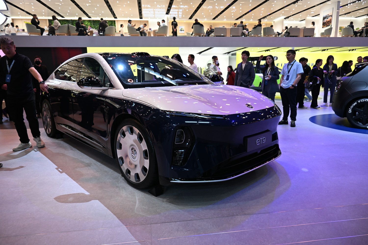 Sleek electric sedan with two-tone body and unique round wheel discs