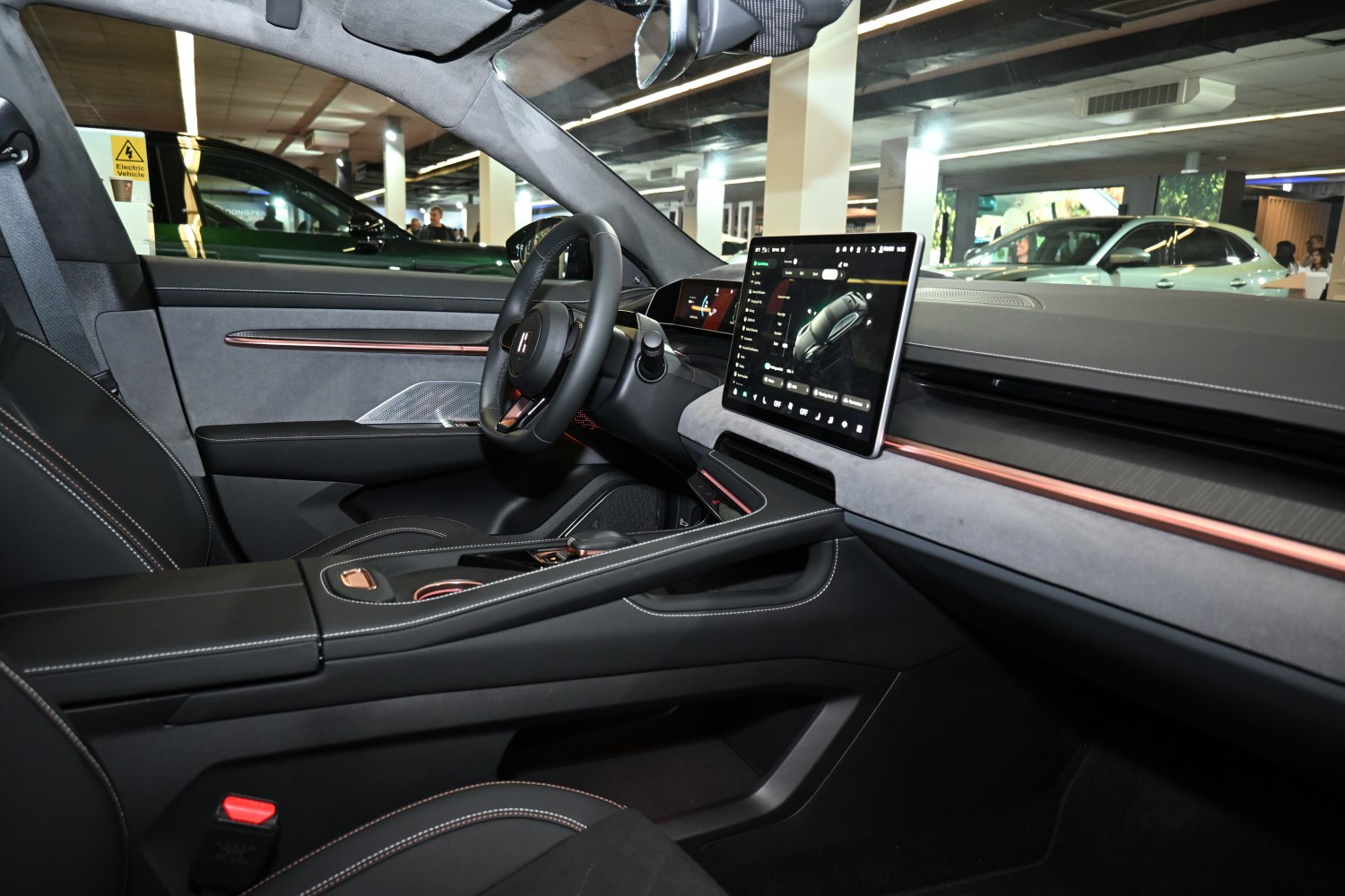 Digital instrument cluster and large central touchscreen in car interior