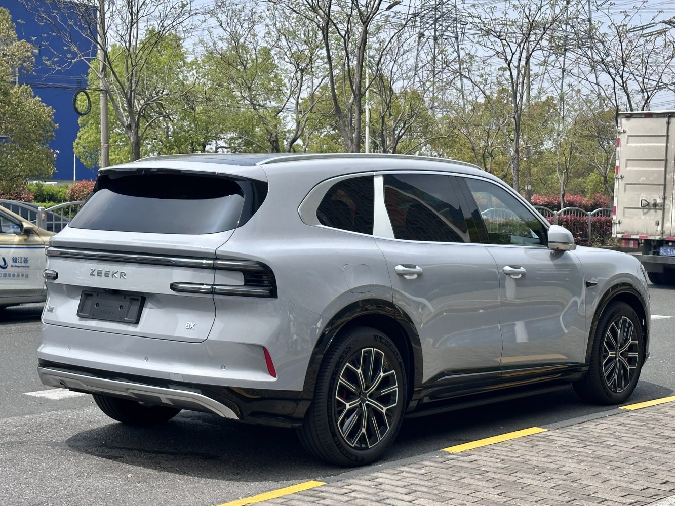 Side and rear profile of a modern electric SUV with distinctive taillights