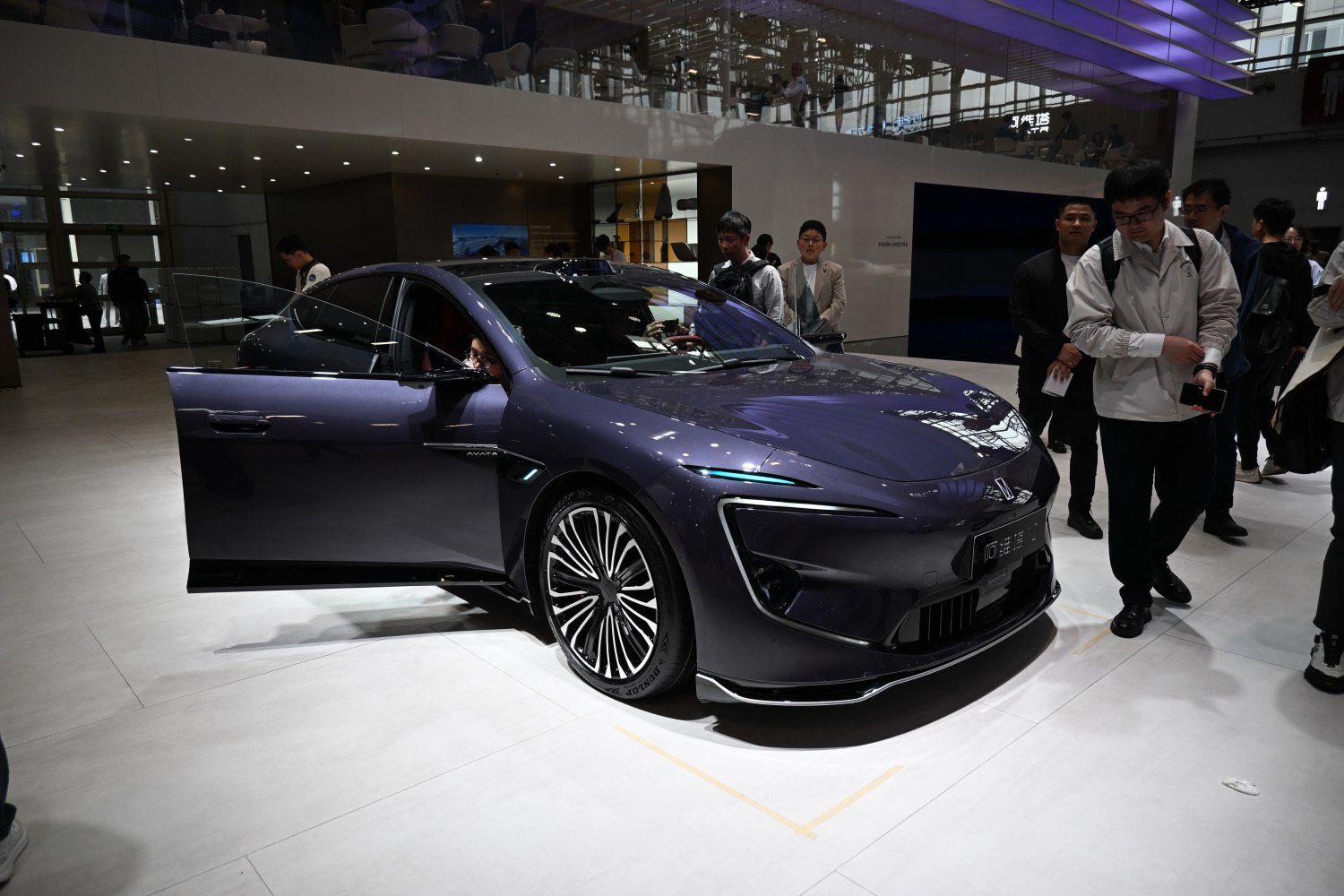 Futuristic LED headlights and open driver door.