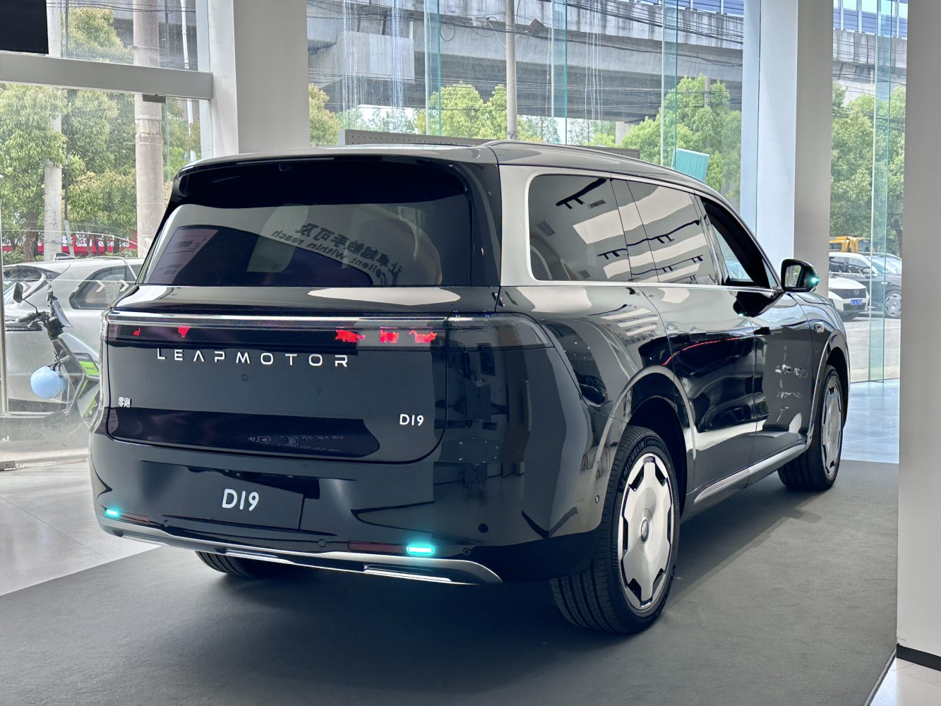 Rear and side view of sleek black electric SUV with LED tail lights and aerodynamic shape