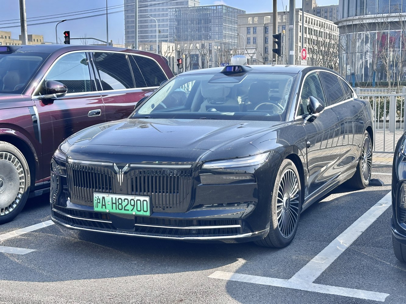 Luxury electric sedan front view with distinctive grille and LED headlights