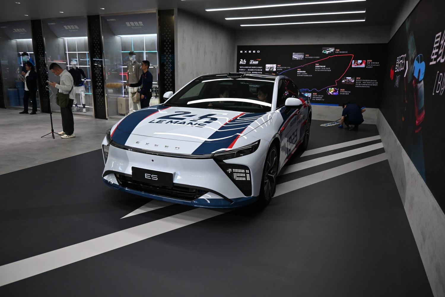 Electric sedan with Le Mans racing livery and distinctive LED headlights
