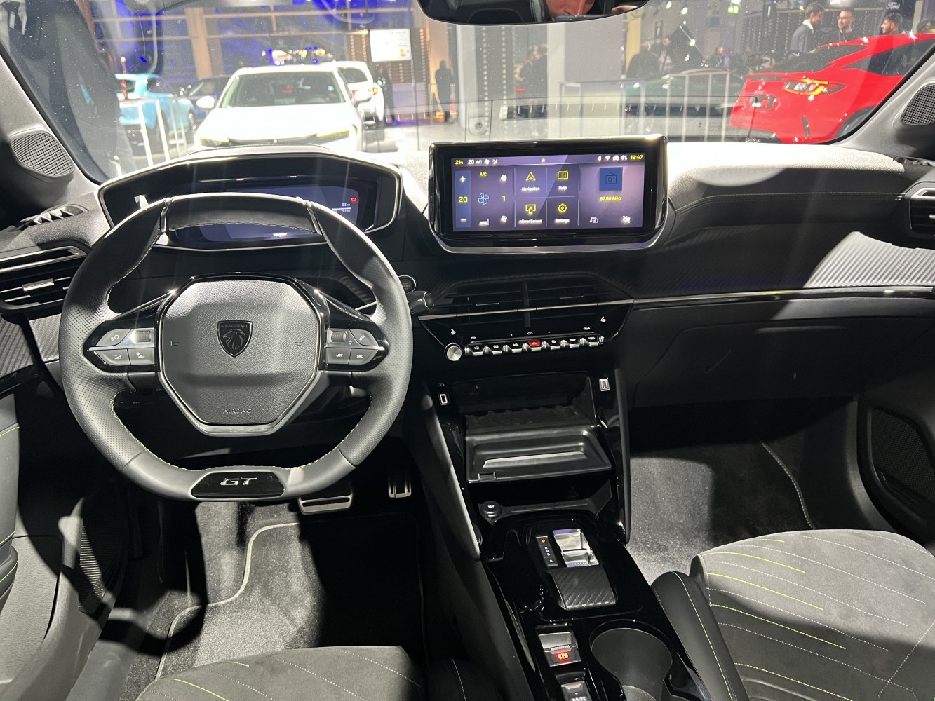 Steering wheel with GT badge and digital dashboard with touchscreen infotainment