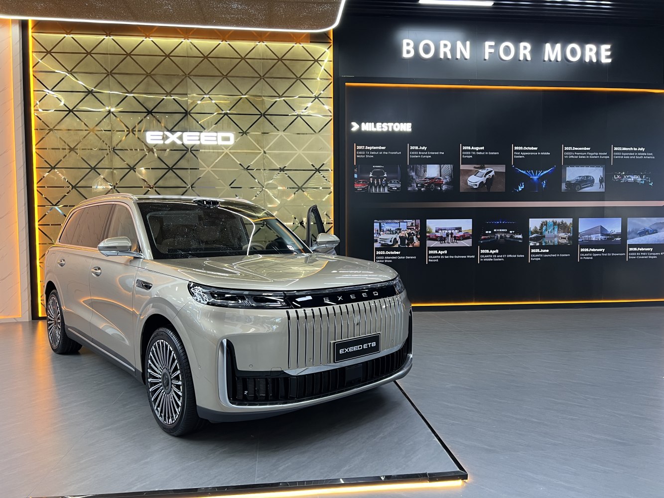 Bold front grille and intricate alloy wheels on SUV in showroom