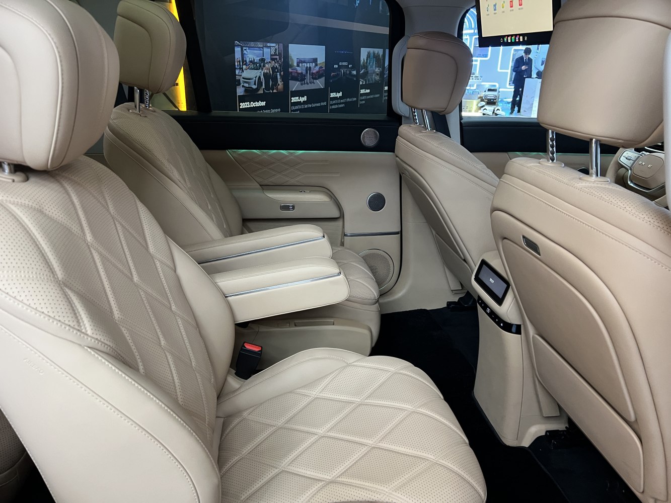 Beige leather rear seats with diamond pattern and foldable armrest