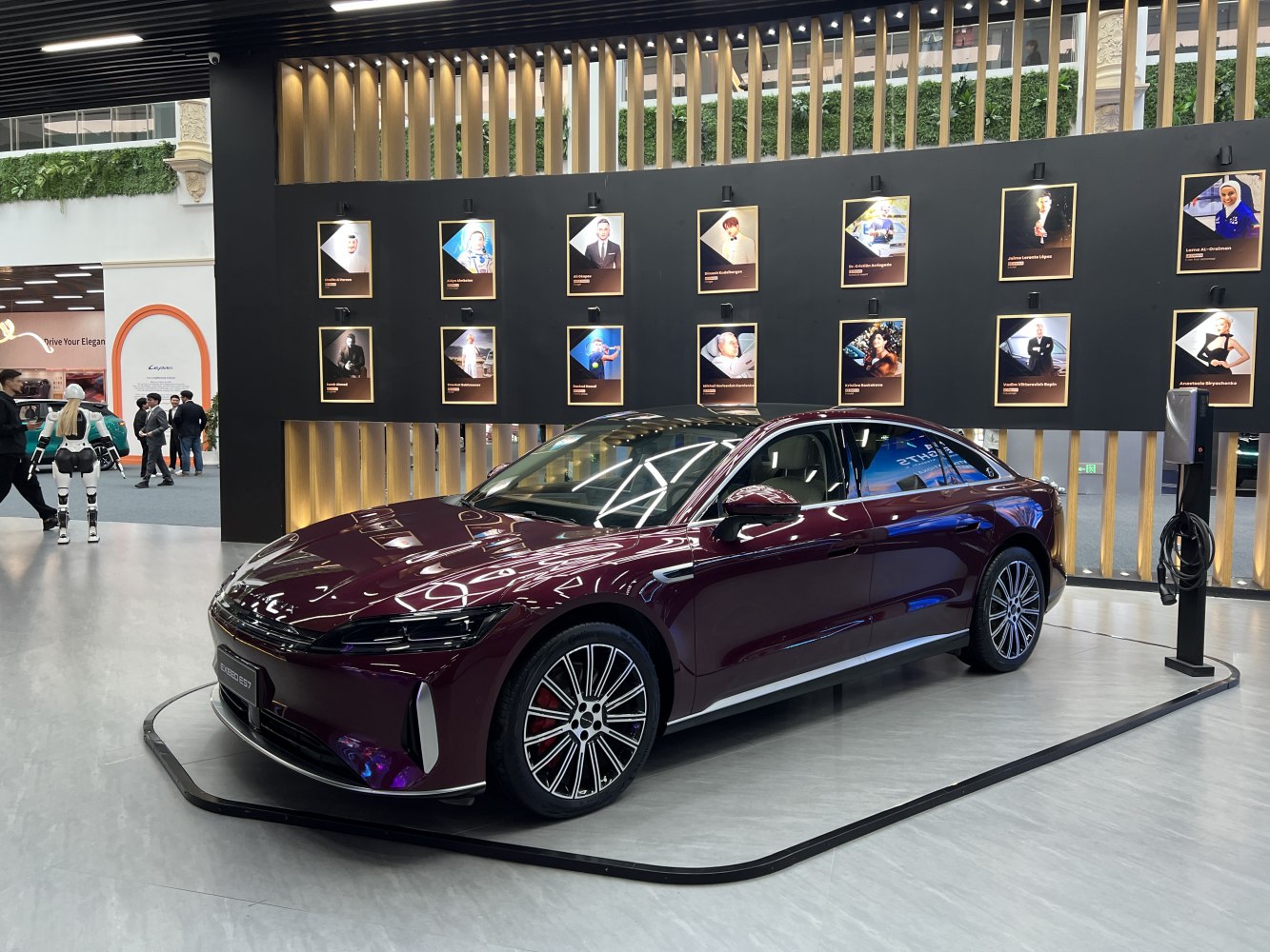 Sleek sedan with LED headlights and alloy wheels showcased indoors