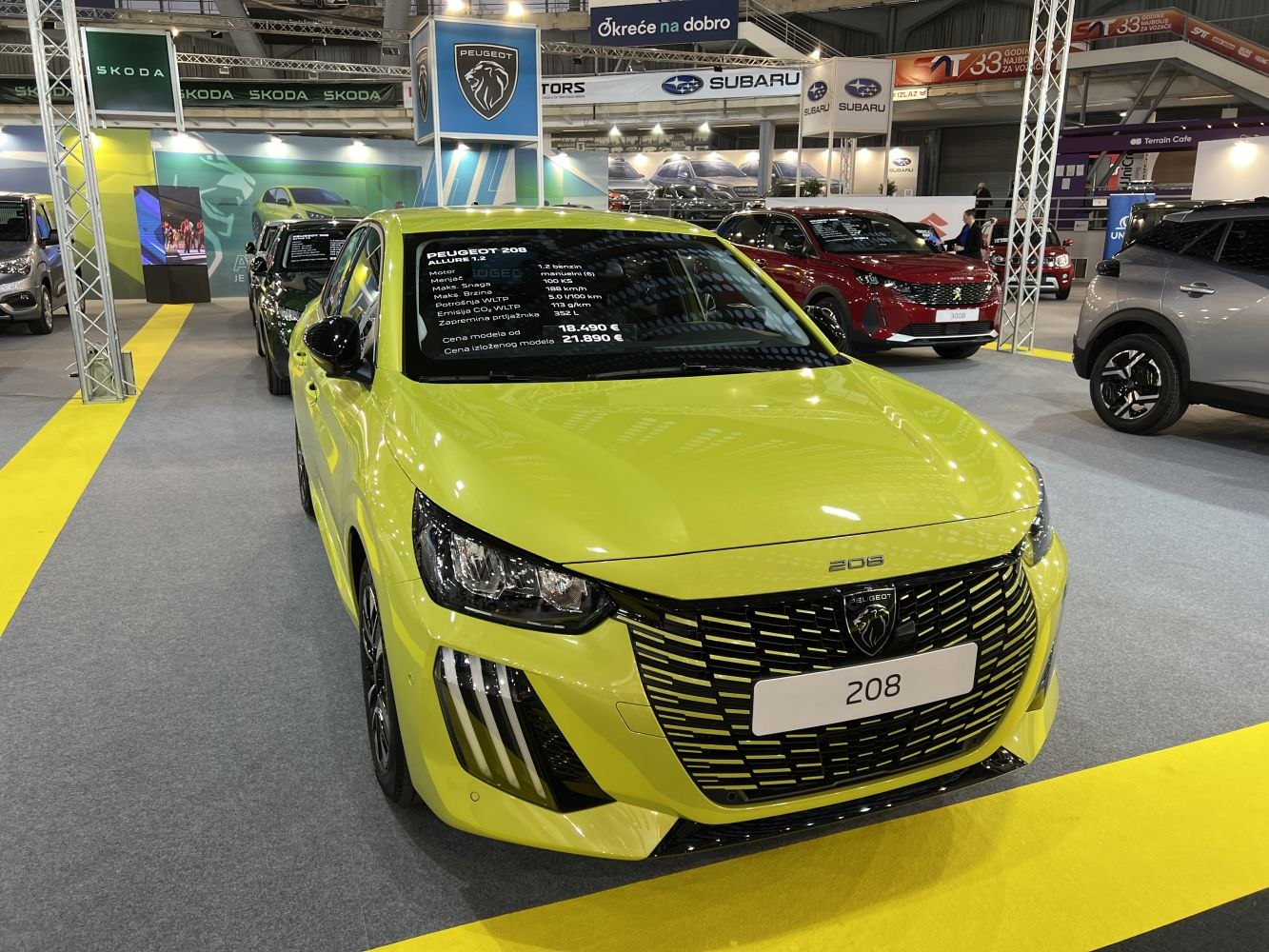 Front grille and modern headlights of yellow hatchback