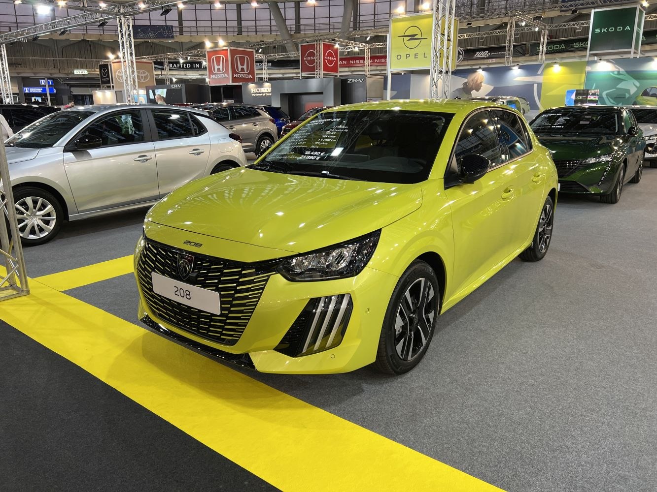 Modern compact hatchback front with LED headlights and bold grille