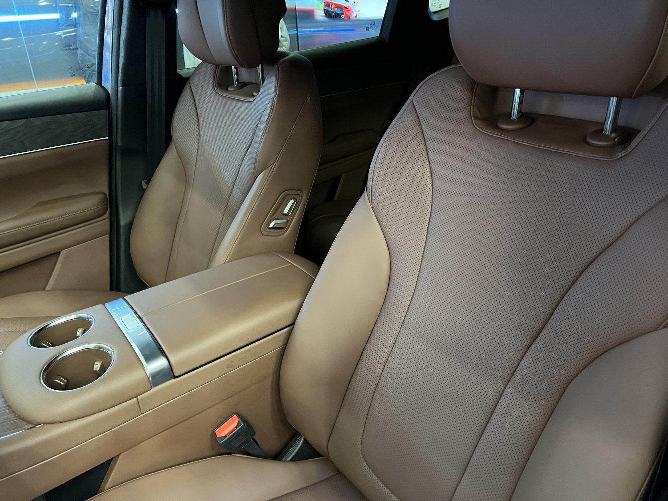 Brown leather seats with adjustable controls and center console cup holders
