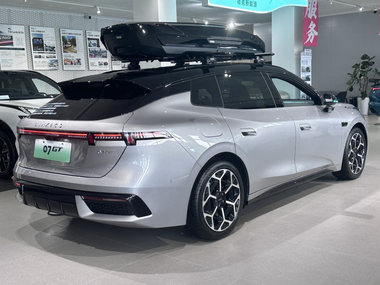 Silver hatchback with roof box and unique alloy wheels