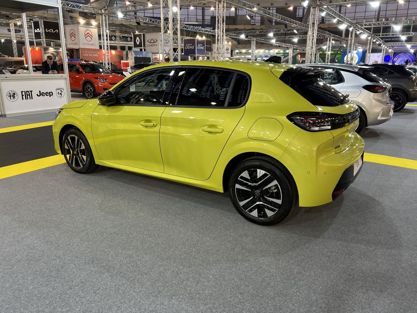 Rear-side view of lime yellow compact hatchback with alloy wheels