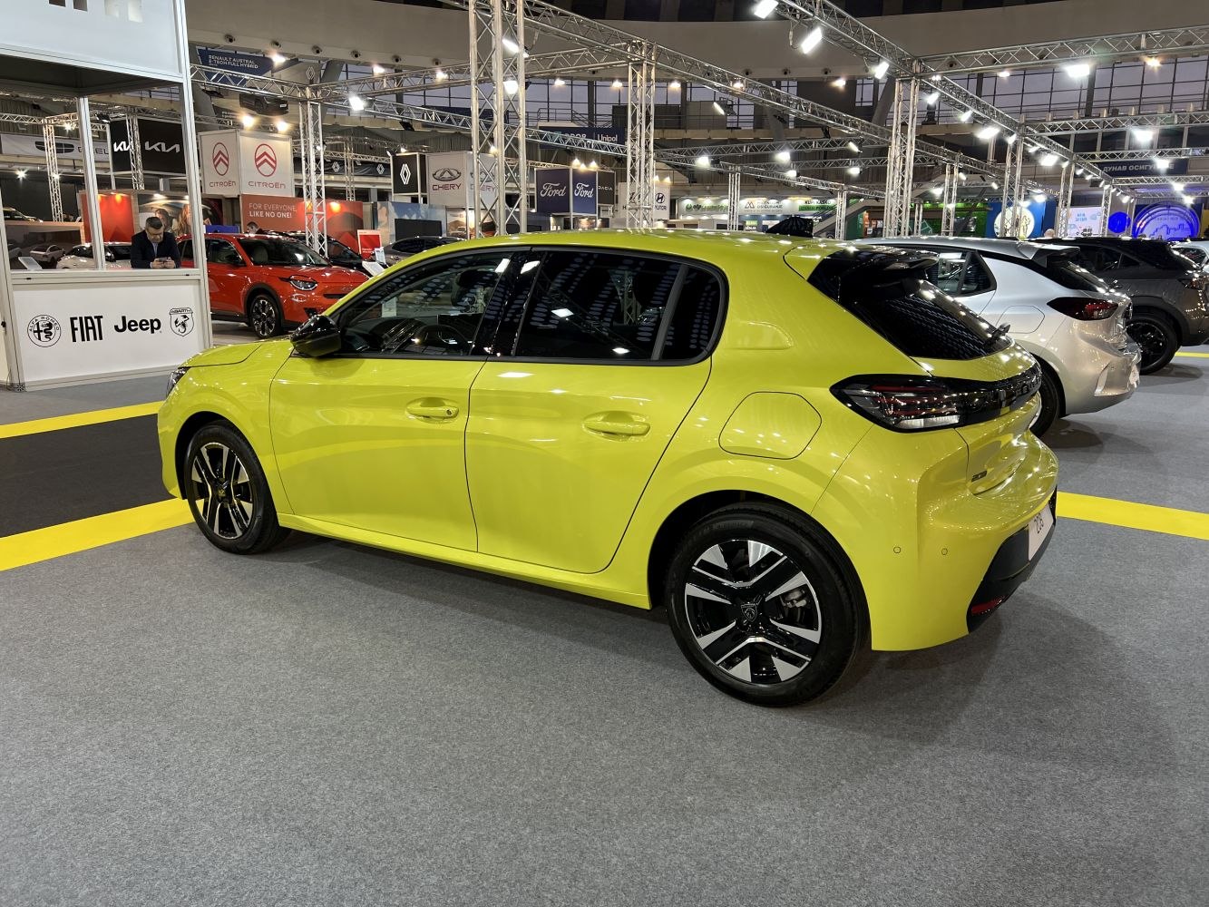 Bright yellow compact hatchback rear and side with alloy wheels