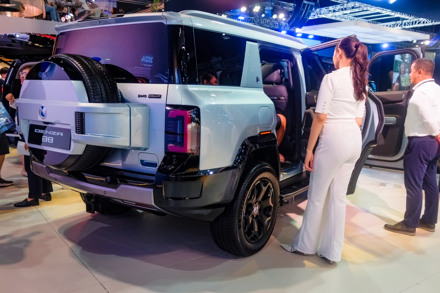 SUV rear side with spare tire mount, taillights, and open doors
