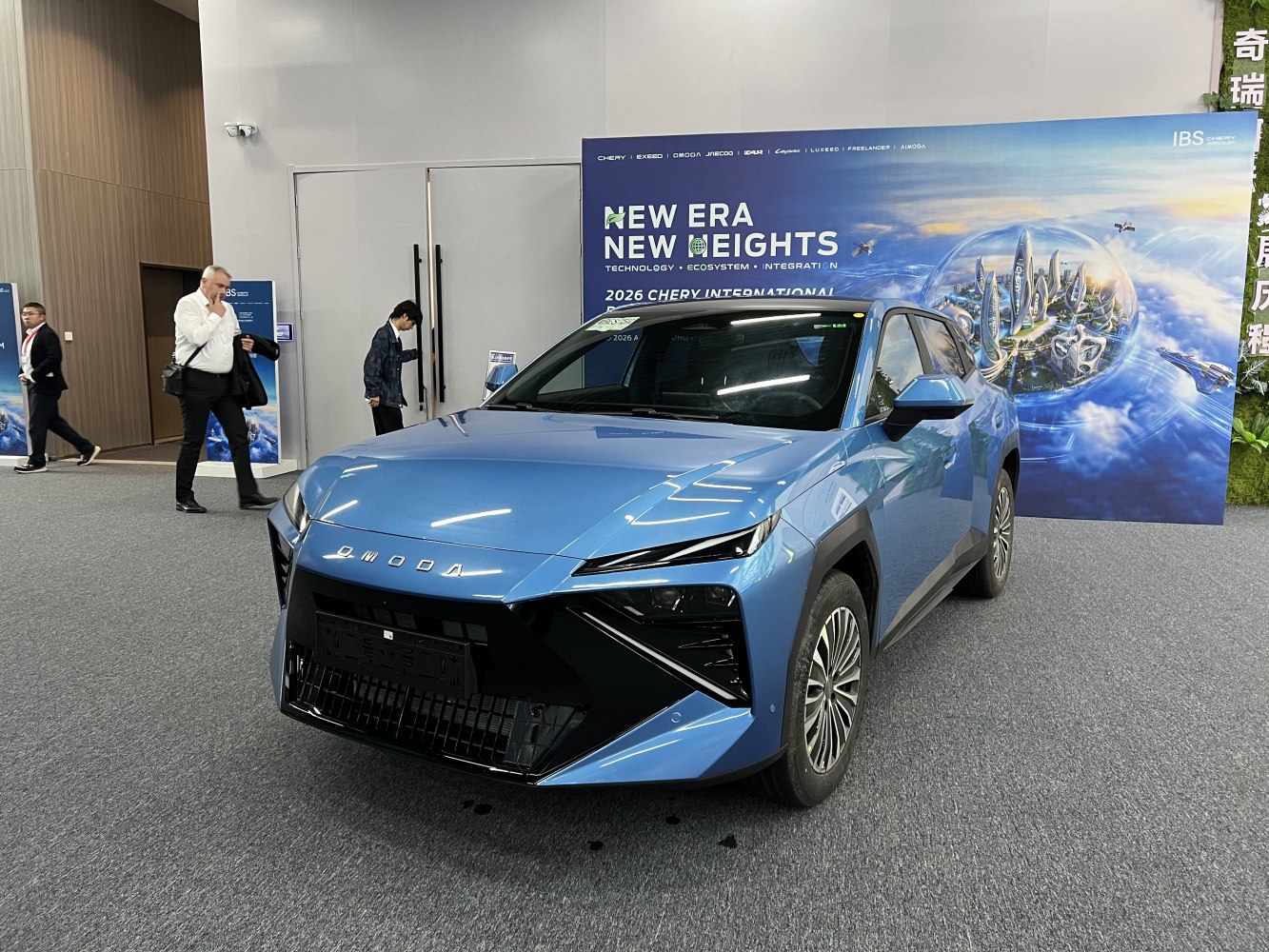 Blue car front with aggressive grille and sleek headlights