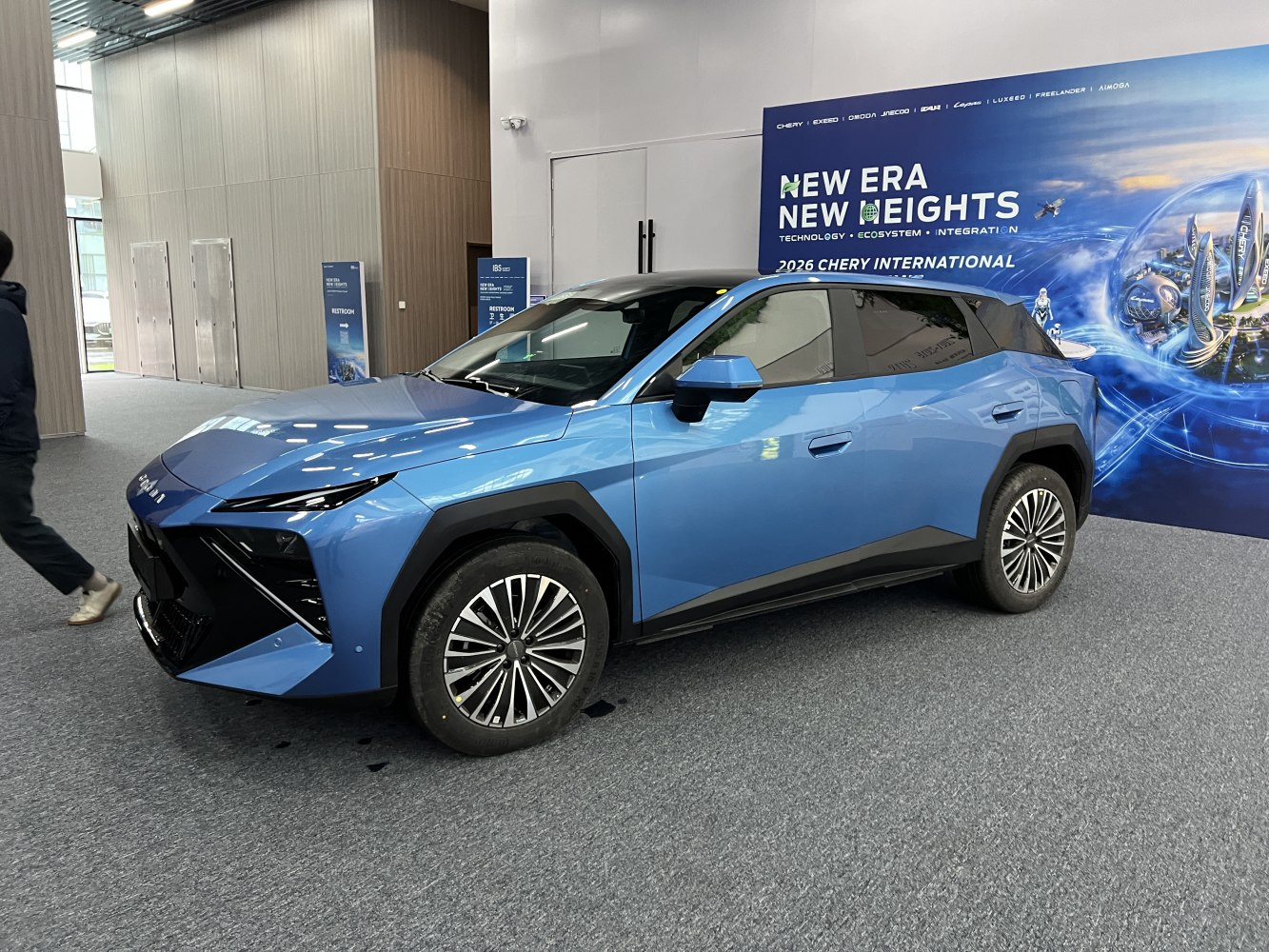 Sharp angular front with LED headlights and aerodynamic side profile in blue.