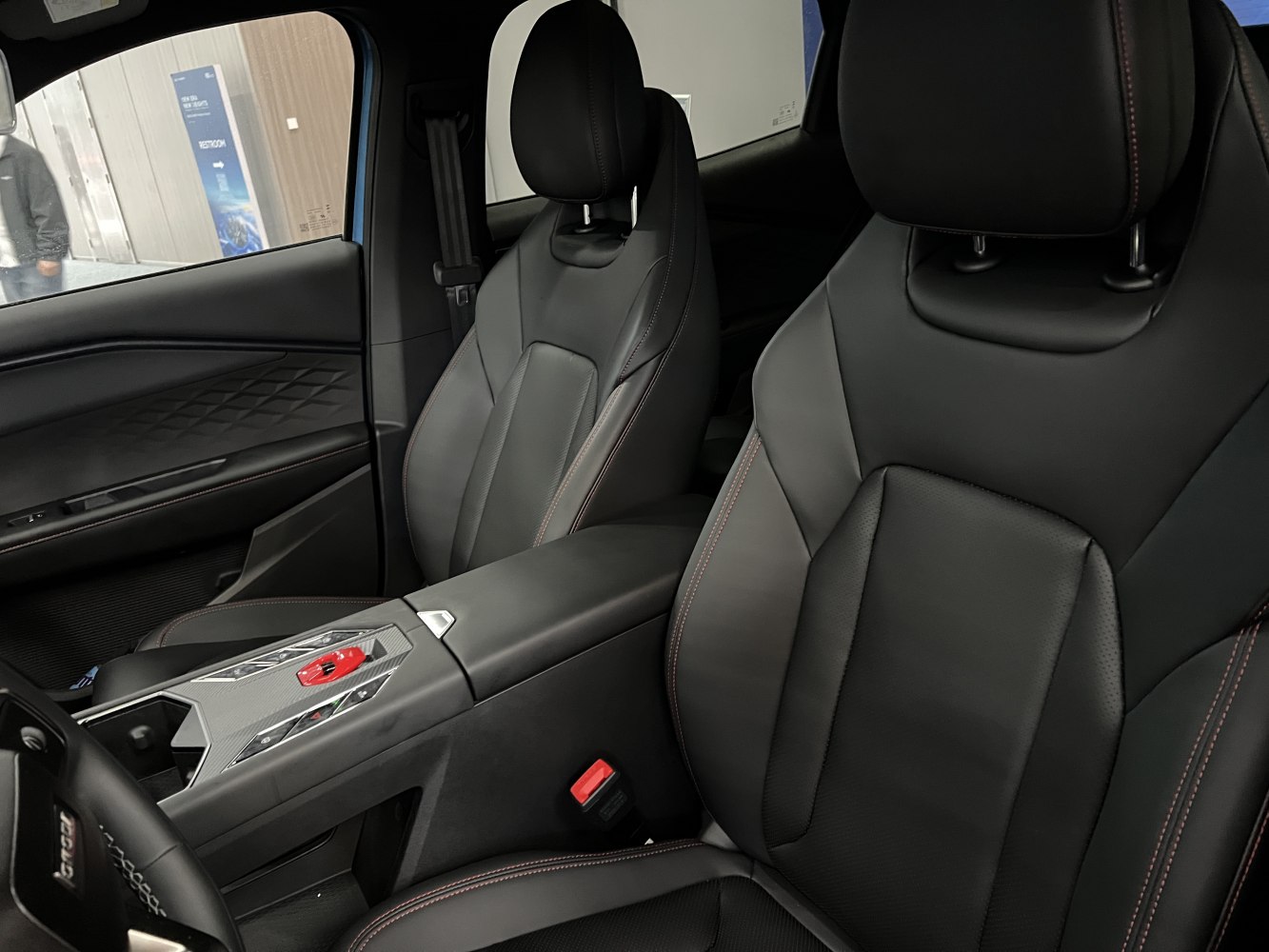 Black leather seats with red stitching and modern center console